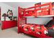 Bedroom with a set of Mickey Mouse themed bunk beds and a dresser at 8511 La Isla Dr, Kissimmee, FL 34747