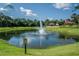 Emerald Island Resort pond with a fountain and lush landscaping at 8511 La Isla Dr, Kissimmee, FL 34747