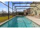 Large screened-in pool with spa and backyard view at 8511 La Isla Dr, Kissimmee, FL 34747