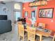 Bright dining room with a large table and orange walls at 8515 Sunrise Key Dr, Kissimmee, FL 34747