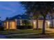 House exterior at night, showcasing landscaping and warm lighting at 8515 Sunrise Key Dr, Kissimmee, FL 34747