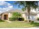 Single-story house with a palm tree and manicured lawn at 8515 Sunrise Key Dr, Kissimmee, FL 34747