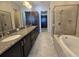 Elegant bathroom with double vanity, soaking tub, and shower at 9121 Laureate Blvd, Orlando, FL 32827