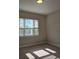 Spacious bedroom with large window and carpeted floor at 9121 Laureate Blvd, Orlando, FL 32827