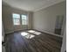 Bright bedroom with wood-look tile floors and large windows at 9121 Laureate Blvd, Orlando, FL 32827