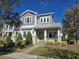 Two-story craftsman style home with green exterior and metal roof at 9121 Laureate Blvd, Orlando, FL 32827