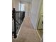 Upstairs hallway with carpeted floors and laundry closet at 9121 Laureate Blvd, Orlando, FL 32827