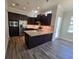 Modern kitchen with dark cabinetry and stainless steel appliances at 9121 Laureate Blvd, Orlando, FL 32827