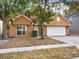 Two-story house with attached garage, landscaping, and a tan exterior at 942 Beresford Way, Lake Mary, FL 32746