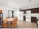 Kitchen with dark brown cabinets, white appliances, and a breakfast nook at 942 Beresford Way, Lake Mary, FL 32746