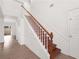 Staircase with wooden railing and tiled flooring in the entryway at 942 Beresford Way, Lake Mary, FL 32746