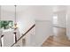 Upstairs hallway with chandelier and view to the entryway at 942 Beresford Way, Lake Mary, FL 32746