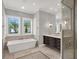 Bathroom with a soaking tub, walk-in shower, and marble vanity at 9512 Tavistock Rd, Orlando, FL 32827