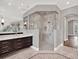 Elegant bathroom with a large glass shower and double vanity at 9512 Tavistock Rd, Orlando, FL 32827