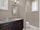 Small bathroom with granite countertop and dark wood vanity at 9512 Tavistock Rd, Orlando, FL 32827