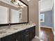 Elegant bathroom with double vanity, granite countertop, and dark wood cabinets at 9512 Tavistock Rd, Orlando, FL 32827