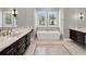 Elegant bathroom with marble countertops and soaking tub at 9512 Tavistock Rd, Orlando, FL 32827