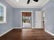 Bright bedroom with hardwood floors and access to a patio at 9512 Tavistock Rd, Orlando, FL 32827