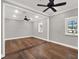 Large bedroom with hardwood floors and ceiling fan at 9512 Tavistock Rd, Orlando, FL 32827