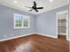 Light blue bedroom with hardwood floors and walk-in closet at 9512 Tavistock Rd, Orlando, FL 32827