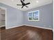 Bedroom with hardwood floors, window with shutters and a closet at 9512 Tavistock Rd, Orlando, FL 32827