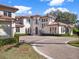 Luxury home with circular driveway and manicured landscaping at 9512 Tavistock Rd, Orlando, FL 32827