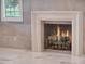 Elegant fireplace with marble surround in living room at 9512 Tavistock Rd, Orlando, FL 32827