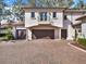 Three-car garage with brick paver driveway at 9512 Tavistock Rd, Orlando, FL 32827