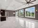 Spacious Gathering room with high ceilings and large windows at 9512 Tavistock Rd, Orlando, FL 32827