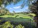 View of the golf course from behind a fence at 9512 Tavistock Rd, Orlando, FL 32827