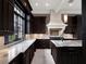 Modern kitchen with marble countertops and dark cabinetry at 9512 Tavistock Rd, Orlando, FL 32827