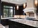 Modern kitchen with marble countertops and dark wood cabinetry at 9512 Tavistock Rd, Orlando, FL 32827