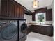 Laundry room with dark wood cabinets and LG washer and dryer at 9512 Tavistock Rd, Orlando, FL 32827