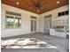 Covered patio with outdoor kitchen and ceiling fan at 9512 Tavistock Rd, Orlando, FL 32827