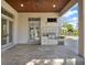 Outdoor kitchen with built-in grill, cabinets, and patio at 9512 Tavistock Rd, Orlando, FL 32827