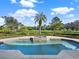 Inviting pool and spa surrounded by greenery at 9512 Tavistock Rd, Orlando, FL 32827