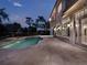 Resort-style pool and spa with expansive patio at dusk at 9512 Tavistock Rd, Orlando, FL 32827