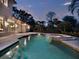 Luxury pool and spa with mosaic tile and tranquil setting at 9512 Tavistock Rd, Orlando, FL 32827