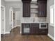 Basement wet bar with dark cabinetry and granite countertop at 9512 Tavistock Rd, Orlando, FL 32827