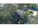 Aerial view of house with pool and backyard, surrounded by trees at 960 Manchester Ave, Oviedo, FL 32765