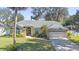 One-story house with a gray roof, a two-car garage, and a landscaped yard at 960 Manchester Ave, Oviedo, FL 32765