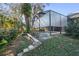 Landscaped backyard featuring lush greenery and stone pathway at 960 Manchester Ave, Oviedo, FL 32765