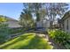 Landscaped backyard with lush greenery and a spacious lawn at 960 Manchester Ave, Oviedo, FL 32765