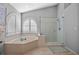 Spa-like bathroom with corner soaking tub and a separate shower stall at 960 Manchester Ave, Oviedo, FL 32765