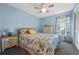 Cozy bedroom with floral bedding and a ceiling fan at 960 Manchester Ave, Oviedo, FL 32765