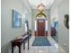 Bright entryway with tile floors, a dark wood console table, and a decorative rug at 960 Manchester Ave, Oviedo, FL 32765