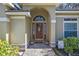 Rich brown front door with arched window and sidelights at 960 Manchester Ave, Oviedo, FL 32765