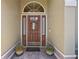 Wood front door with arched window and sidelights at 960 Manchester Ave, Oviedo, FL 32765