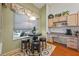 Kitchen nook with small table and chairs, looking out to a pool at 960 Manchester Ave, Oviedo, FL 32765