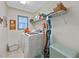 Bright laundry room with washer, dryer, and ample shelving at 960 Manchester Ave, Oviedo, FL 32765